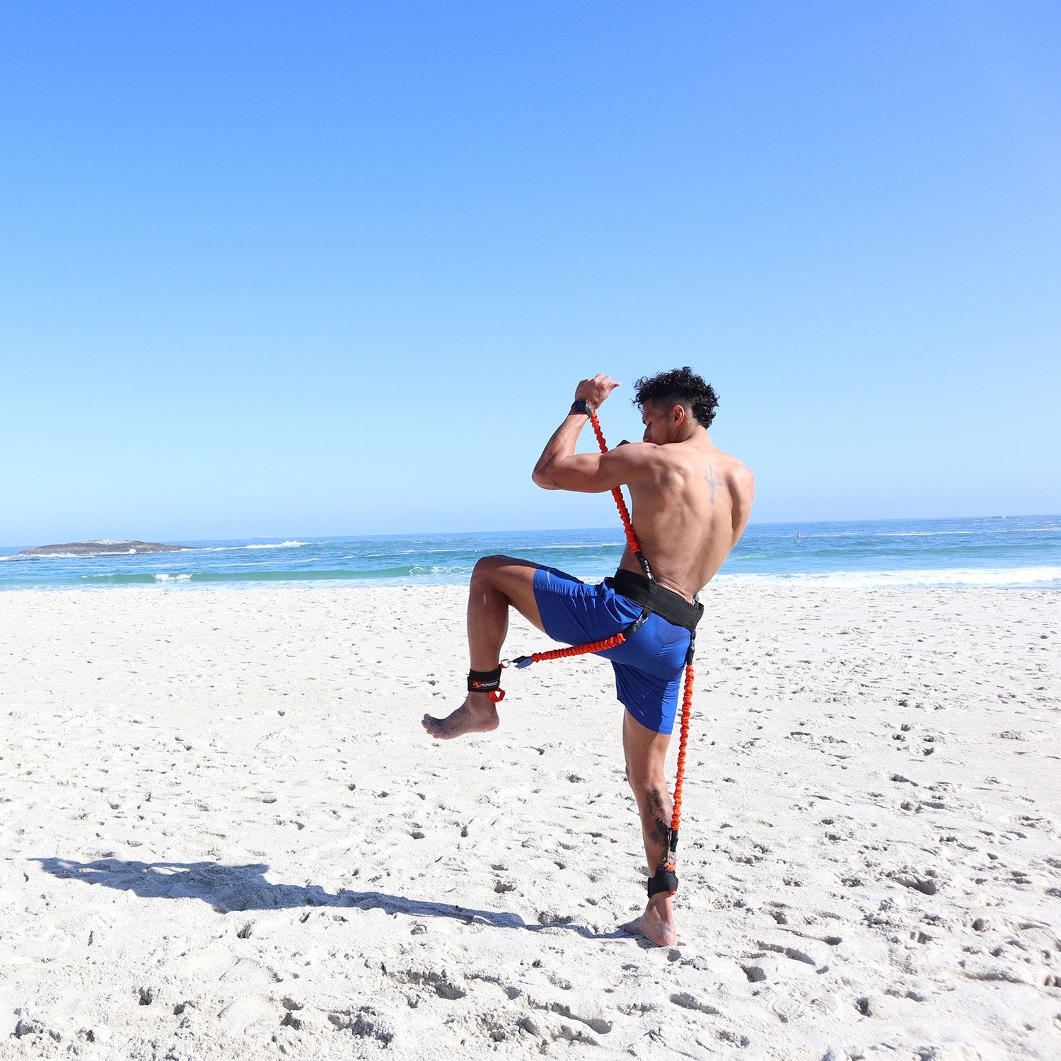 a man on a beach throwing a frisbee 